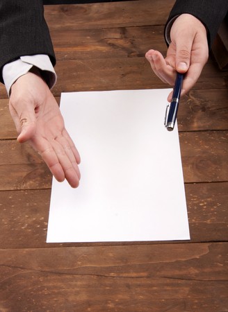 part of hands signing a contractの写真素材