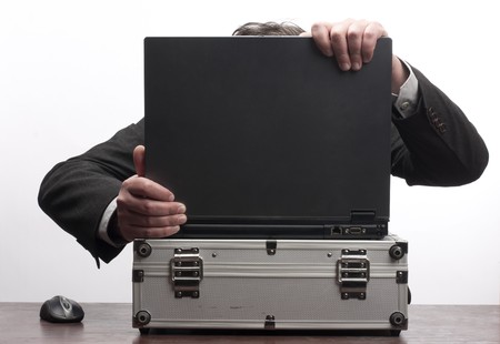 Man hide behind computer close upの写真素材