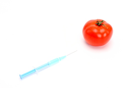 Syringe injecting tomato close upの写真素材