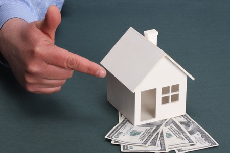 parts of hands with house and moneyの写真素材