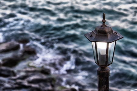Vintage street lamp  and sunset on seaの写真素材