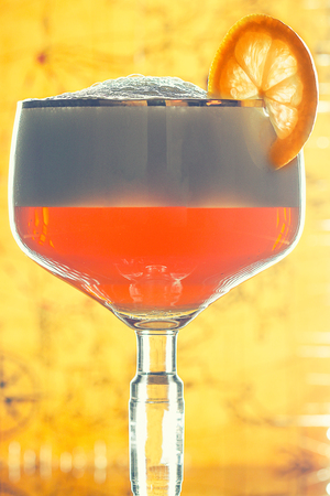 A glass of weiss beer isolated with slice of lemonの写真素材