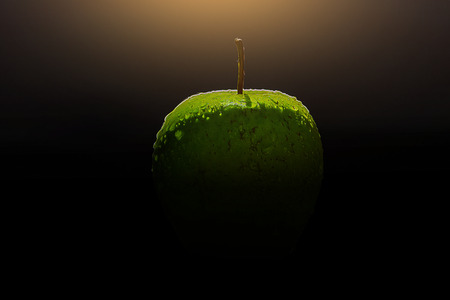 Apple isolated on black, with water drops.の写真素材
