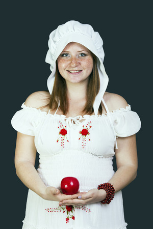 Redhead beauty with an apple in his handの写真素材