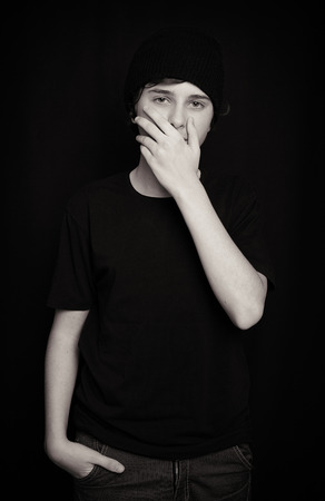 Portrait of a teen boy in a black capの写真素材
