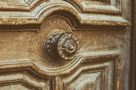 Door handle on an antique wooden doorの写真素材