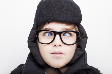 Handsome boy is wearing eyeglasses and making squint. Isolated on white backgroundの写真素材