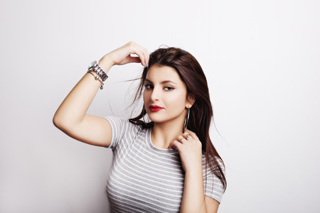 Young attractive woman with long black hair on white background.の写真素材