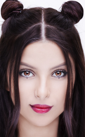 beautiful woman with bright makeup hairstyle with horns on a white backgroundの写真素材