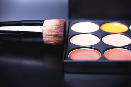 Palette concealer and correctors. Make-up base. Isolated on black backgroundの写真素材
