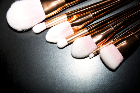 Professional makeup brushes collection on black background