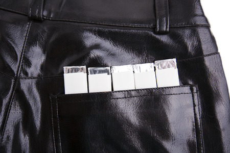 Chewing gums in the back pocket of black pantsの写真素材