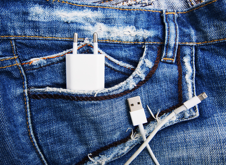 White USB cable in jeans pocket USB cord with the jeans pocket. Close-up