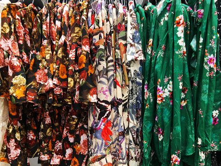 Women's blouses on a hanger in the store.  Clothes hang on a shelf in a clothes storeの写真素材
