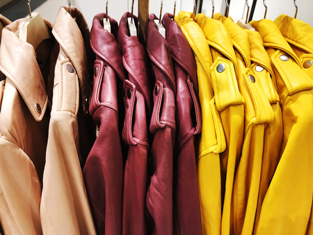 Modern clothes in a shop on a hanger. Clothes of different styles on the hanger in the showroom.の写真素材