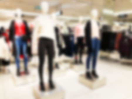 Blurred mannequins in a clothing shop in shopping mall. Abstract blurred background