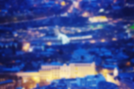 City lights bokeh blur effect at night. Unfocused blurred urban abstract backgroundの写真素材
