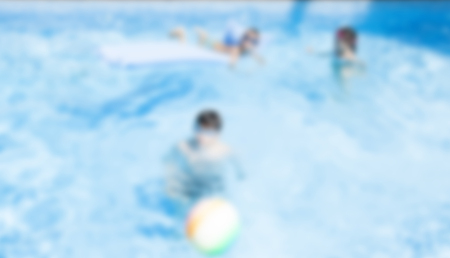 Blurred image of people relaxing at swimming pool - recreational background conceptの写真素材