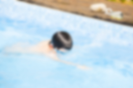 Blurred image of people relaxing at swimming pool - recreational background conceptの写真素材