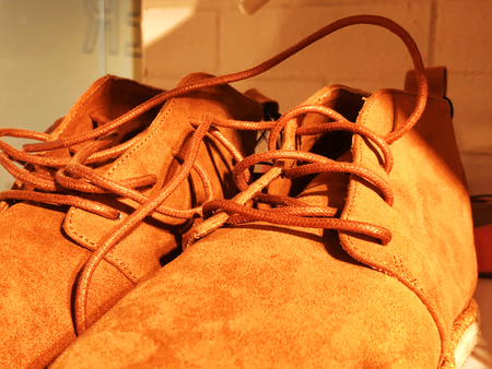 Women's fashion boots in the store on the shelf close-up.
