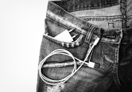 White USB cable in jeans pocket USB cord with the jeans pocket. Close-upの写真素材