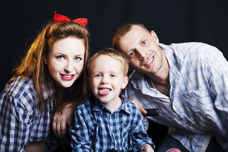 happy family in the studio on a black background.の写真素材