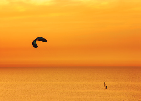Sunset over the sea and extreme freestyle sports windsurfing in Israelの写真素材