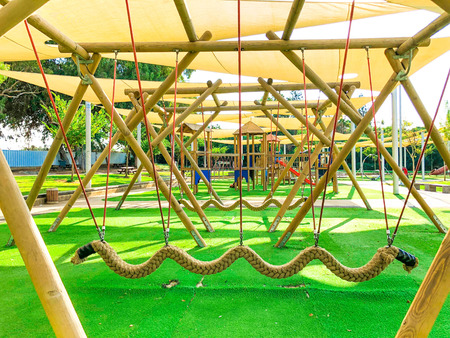 Public's playground in city. Colorful playground on yard in the park. Park with set of modern kids...