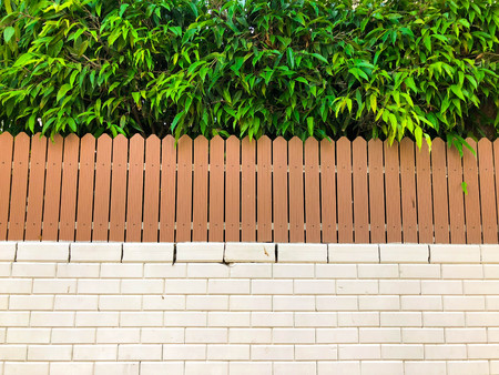 Stone with wooden fence with green lawn and landscape.の写真素材