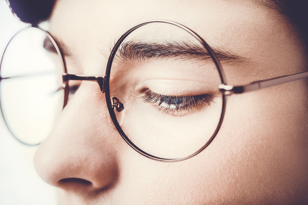 Portrait of a boy wearing eyeglasses blue eyes close, macro studio shotの写真素材