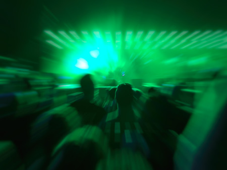 Abstract motion blur effect. Bokeh lighting in concert with audience.の写真素材