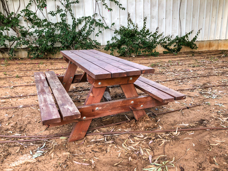 Wooden table with wooden seats in the park.