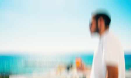 Man enjoying on blue sky sea outdoors background. Abstract motion blur effect