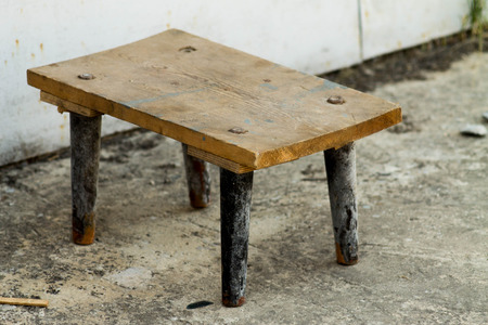 A wooden old chair near the garage. Soviet style.の写真素材