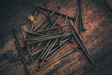 Rusty nails macro on the wooden background, toned.の写真素材