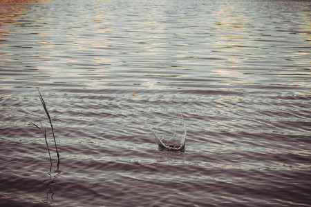 Splashing water from a stone that fell into a river.の写真素材