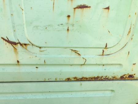 Background with an iron rusty door from the car. Close up shot.の写真素材