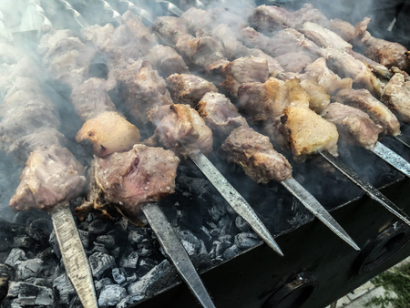 Mcvadi - shashlik preparing on a barbecue grill over charcoal. Roasted stacked meat Shish kebab popular in Goergia. Traditional cuisine in Georgia.の写真素材