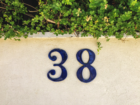 Number 38 on the front of the house, close up.の写真素材