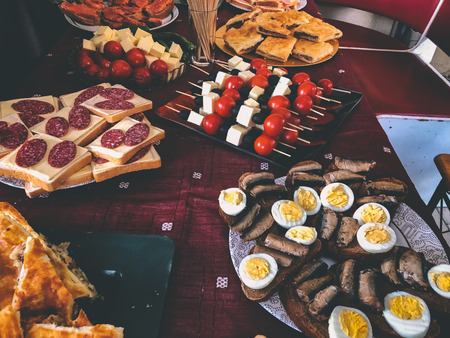 Buffet dinner at the cottage. Feast on the nature, sandwiches, pie with meat, khachapuri, fish, vegetables, boiled eggs.の写真素材