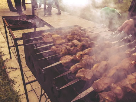 Mcvadi - shashlik preparing on a barbecue grill over charcoal. Roasted stacked meat traditional cuisine in Georgia.の写真素材