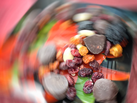 Motion effect  Dried fruits and chocolates on a plate. Close up shot.の写真素材