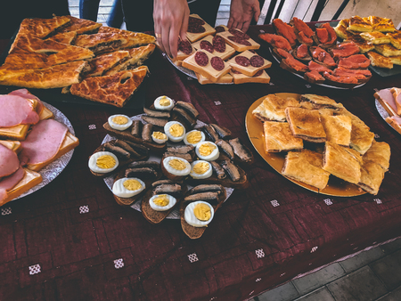 Buffet dinner at the cottage. Feast on the nature, sandwiches, pie with meat, khachapuri, fish, vegetables.の写真素材