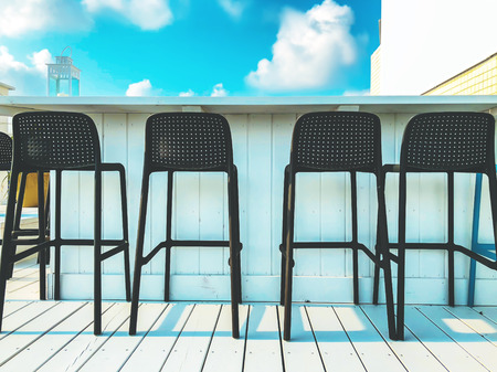 Vacant seats at the open-air bar on the roof.の写真素材