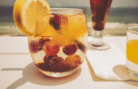 Cocktail drink on wood table on the sky background. Chill out and summer holiday concept.の写真素材