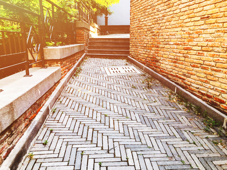 Stone steps and brick wall on a sunny day in Tbilisi.の写真素材