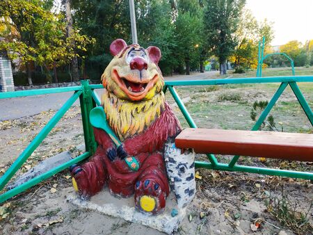Wooden sculpture on the playground. Smiling bear.の写真素材