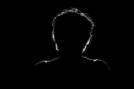 Unknown male person silhouette on black background.