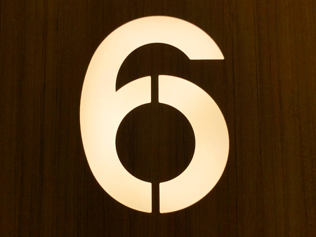 Number 6 on the front of the house, close up.