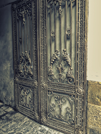 Entrance to the courtyard. Iron-forged gates decor and ornament in the city streets. Old Tbilisi architecture.の写真素材